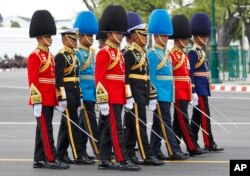 The royal honor guard walk in the funeral procession and royal cremation ceremony of late Thai King Bhumibol Adulyadej, in Bangkok, Thailand, Oct. 26, 2017.