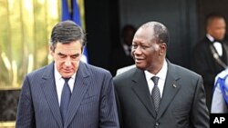 Ivory Coast's President Alassane Ouattara walks with French Prime Minister Francois Fillon at the presidential palace in Abidjan, July 15, 2011
