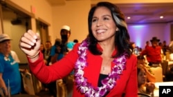 FILE - In this Nov. 6, 2018, file photo, Rep. Tulsi Gabbard, D-Hawaii, greets supporters in Honolulu. Gabbard has announced she’s running for president in 2020. 