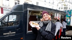 French Valentine Davase poses in front of her 'Le Refectoire' food truck in Paris November 16, 2012.