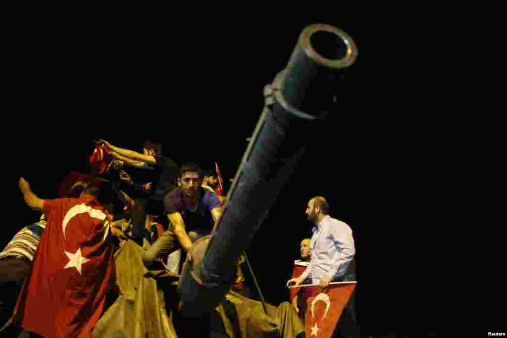 People surround a Turkish army tank in Ankara, Turkey, July 16, 2016.