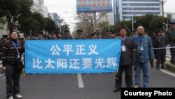 Wu Gan, right, takes part in a demonstration outside a court in Fuzhou, Fujian province. Wu is awaiting a decision in his trial.