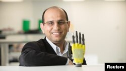 Ravinder Dahiya of the University of Glasgow’s School of Engineering poses with the prosthetic hand developed by his team at Glasgow University, Scotland, March 11, 2017. 