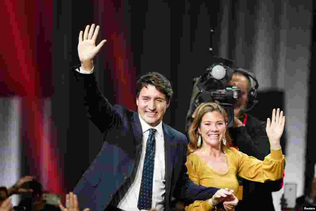 Liberal leader and Canadian Prime Minister Justin Trudeau and his wife Sophie Gregoire Trudeau wave to supporters after the federal election at the Palais des Congres in Montreal, Quebec, Canada. Trudeau&#39;s Liberals held onto power after a closely fought election but were reduced to a minority government that will need the support in Parliament of a smaller left-leaning party.