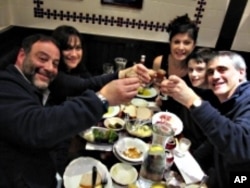 The Plaut family and friends give a hearty 'L'chaim' toast with some deli chocolate soda.