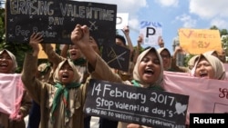 Muslim students shout slogans during a protest against Valentine's Day celebrations in Surabaya, Indonesia, Feb. 13, 2017 in this photo taken by Antara Foto.