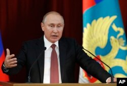 Russian Vladimir Putin gestures during a meeting with Russian ambassadors to foreign countries in Moscow, July 19, 2018.