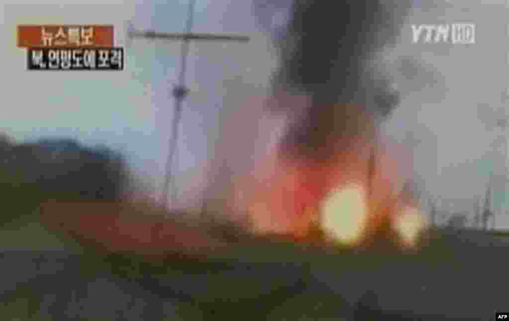 In this image take from TV footage, smoke rises from South Korea's Yeonpyeong island near the border against North Korea, Tuesday, Nov. 23, 2010. North Korea shot dozens of rounds of artillery onto the populated South Korean island near their disputed wes