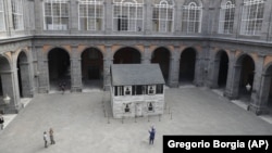 The house of U.S. civil rights campaigner Rosa Parks, rebuilt by artist Ryan Mendoza, is on display in the courtyard of an 18th century Royal Palace, in Naples, Italy, Tuesday, Sept. 15, 2020. (AP Photo/Gregorio Borgia)