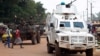 Police officers from the United Nations Multidimensional Integrated Stabilization Mission in the Central African Republic (MINUSCA) in an armored vehicle patrol a market in Bangui's Combattant district, Sept. 14, 2015.