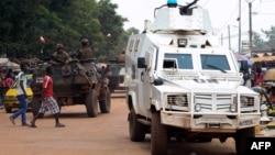 Police officers from the U.N. Multidimensional Integrated Stabilization Mission in the Central African Republic (MINUSCA) in an armored vehicle patrol a market in Bangui's Combattant district, Sept. 14, 2015.