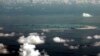 FILE - This aerial photo taken through a military plane window shows China's alleged reclamation of Mischief Reef in the Spratly Islands in the South China Sea, May 11, 2015.