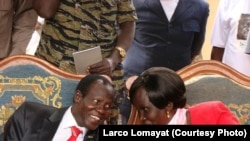 FILE - South Sudan Vice President James Wani Igga speaks with Rebecca Nyandeng, widow of the founding father of South Sudan, John Garang.