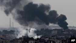 Smoke from Israeli strikes rises over Gaza City, in the northern Gaza Strip, July 27, 2014. 