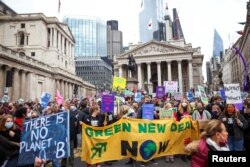 Demonstrators participate in a protest outside the Bank of England, as the UN Climate Change Conference (COP26) takes place, in London, Britain, Nov. 6, 2021.