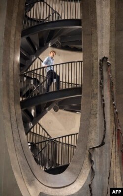 A visitor walks on a stairway in The Zeitz Museum of Contemporary African Art in Cape Town, Sept. 15, 2017.