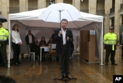 Colombia's President Juan Manuel Santos speaks after after voting in a referendum to decide whether or not to support the peace deal he signed with rebels of the Revolutionary Armed Forces of Colombia, FARC, in Bogota, Colombia, Sunday, Oct. 2, 2016.