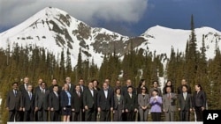 Apec senior officials gather for a group photo with Lone Peak in the background on the first day of the APEC senior officials meeting in Big Sky, Montana, May 18, 2011