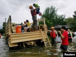 Texas National Guard soldiers aid residents in heavily flooded areas from the storms of Hurricane Harvey in Houston, Texas, Aug. 27, 2017
