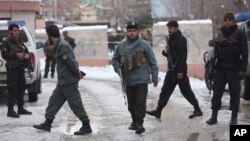 Police officers inspect the site of suicide attack at the Supreme Court in Kabul, Afghanistan, Tuesday, Feb. 7, 2017. (AP Photo/Rahmat Gul)