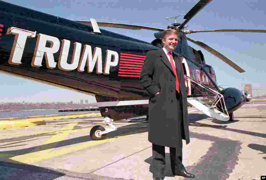 Real estate magnate Donald Trump poses in front of one of three Sikorsky helicopters at New York Port Authority's West 30 Street Heliport on March 22, 1988. (AP Photo/Wilbur Funches)