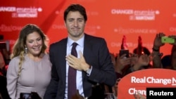 Liberal Party leader Justin Trudeau stands with his wife, Sophie Gregoire, as he gives his victory speech after Canada's federal election in Montreal, Quebec, Oct. 19, 2015. 