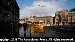 FILE - A road signs reads "Beware of Traffic from Right," in Edinburgh, Scotland, Aug. 31, 2019. Disgruntlement over Brexit and the coronavirus pandemic are breathing new life into the push for Scottish independence.