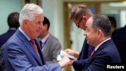 Polish Minister for European Affairs Konrad Szymanski, right, and the European Union's chief Brexit negotiator, Michel Barnier, attend an EU General Affairs Council meeting in Brussels, Belgium, Sept. 18, 2018.