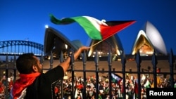 Participants of a pro-Palestinian rally react outside the Sydney Opera House in Sydney, Oct. 9, 2023