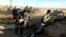 FILE - Iraqi security forces take combat positions on the front line with Islamic State group militants in Ramadi, capital of Iraq's Anbar province, 115 kilometers (70 miles) west of Baghdad, Dec. 10, 2015. 