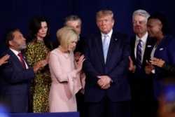 FILE - Faith leaders pray with President Donald Trump during a rally for evangelical supporters at the King Jesus International Ministry church in Miami.