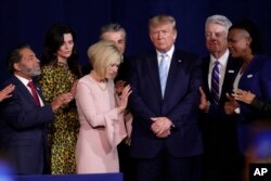 FILE - Faith leaders pray with President Donald Trump during a rally for evangelical supporters at the King Jesus International Ministry church in Miami.