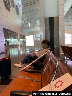 Dunnapar "Fern" Tilakamonkul sat in a row of empty chairs at an airport in Doha, Qatar, during a 16-hour transit before flying to Iraq.
