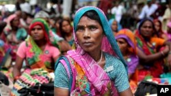 FILE - Indian women farmers gather near the Indian parliament in New Delhi, India, July 24, 2015. In a campaign launched this week, activists in South Asia are appealing to men to stand up for the property rights of their daughters, wives and sisters.