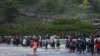 Salvadorean migrants heading in a caravan to the US, cross the Suchiate River to Mexico, as seen from Ciudad Tecun Uman, Guatemala, Nov. 2, 2018.