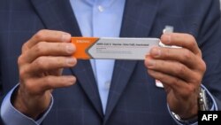 BRAZIL – Sao Paulo Governor Joao Doria shows to members of the media a package of the CoronaVac vaccine that arrived from China at Guarulhos International Airport, Sao Paulo, Brazil, on November 19, 2020.