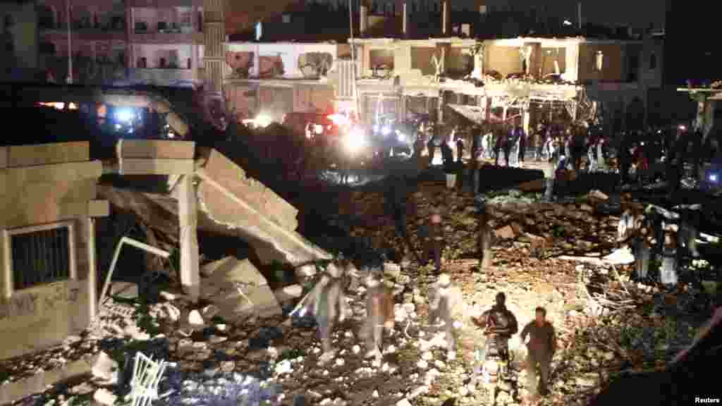 Residents gather at a site hit by what activists say was a Scud missile from forces loyal to Syria's President Bashar al-Assad in Raqqa, Nov. 28, 2013.