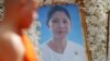 A Buddhist monk leads a funeral procession past a portrait photo of Ouk Phalla, Prince Norodom Ranariddh wife, during her cremation ceremony, in Phnom Penh, Cambodia, Wednesday, June 20, 2018. Ouk Palla was killed in a car driven by Ranariddh who himself was seriously injured early June 17. (AP Photo/Heng Sinith)