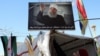 FILE - A sign depicting Syrian Druze leader Sheikh Hikmat al-Hajri is seen in Suwayda, Syria, Feb. 25, 2025.