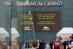 The MGM Grand hotel-casino, which is closing, flashes messages on their marquees, March 16, 2020, in Las Vegas, Nevada.