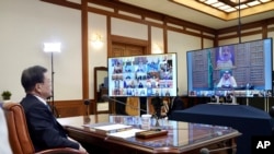 In this photo provided by South Korea's Presidential Blue House via Yonhap News Agency, President Moon Jae-in attends a G-20 virtual summit to discuss the coronavirus outbreak, in Seoul, March 26, 2020.