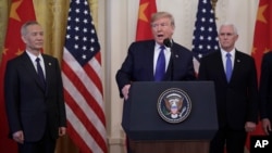 China's Vice Premier Liu He gestures to the media between U.S. Trade Representative Robert Lighthizer (L) and Treasury Secretary Steve Mnuchin before the two countries' trade negotiations in Washington, U.S., October 10, 2019.