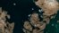 The satellite image, which was captured by Sentinel-2A on July 9, 2018, provided by European Space Agency esa on July 18, 2018 shows a huge iceberg perilously close to the village of Innaarsuit on the west coast of Greenland.