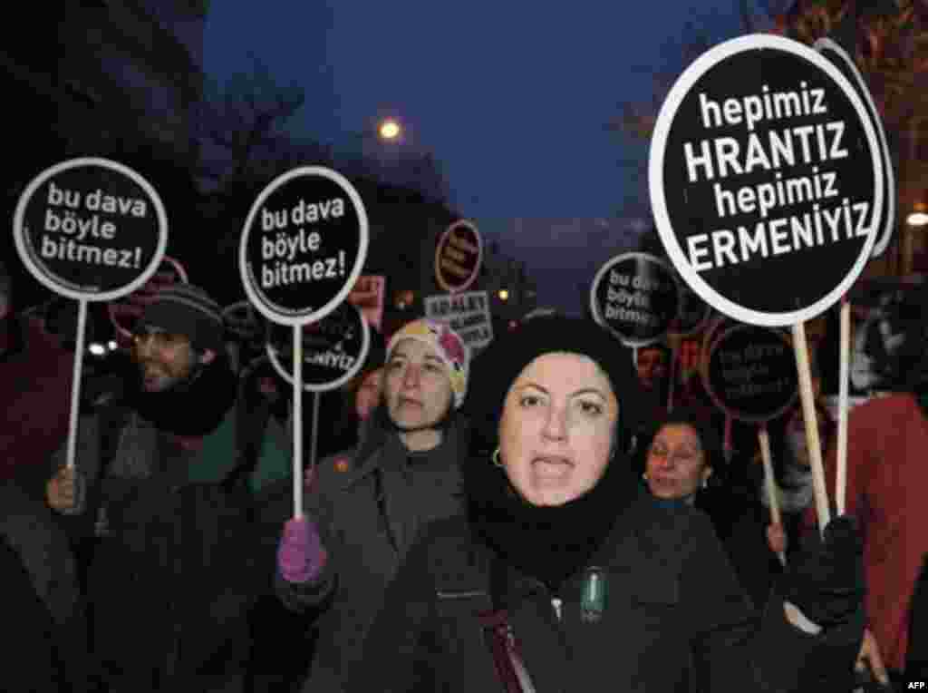 Hundreds of protesters hold placards that read 'We are all Armenians' as they shout slogans outside a courthouse in Istanbul, Turkey, Tuesday, Jan. 17, 2012. A Turkish court on Tuesday sentenced a man to life in prison for masterminding the killing of an 