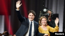 Liberal leader and Canadian Prime Minister Justin Trudeau and his wife Sophie Gregoire Trudeau wave to supporters after the federal election at the Palais des Congres in Montreal, Quebec, Canada October 22, 2019. 