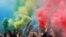 People holding colored smoke flares take part in a festive event in Minsk, Belarus.