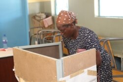 An elderly woman prepares to cast her vote in Gaborone during Botswana's general election. (Mqondisi Dube/VOA)