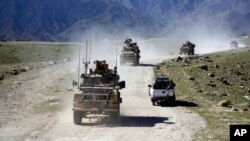 FILE - U.S. forces and Afghan commando patrol in the Achin district of Jalalabad, east of Kabul, Afghanistan, April 2014.