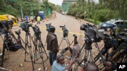 Local and foreign television crews line up behind a police cordon at the end of a street leading to the Westgate Mall in Nairobi, Kenya (AP Photo/Ben Curtis)