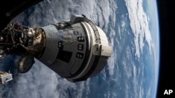 FILE - In this photo provided by NASA, Boeing's Starliner spacecraft is docked to the Harmony module of the International Space Station on July 3, 2024.